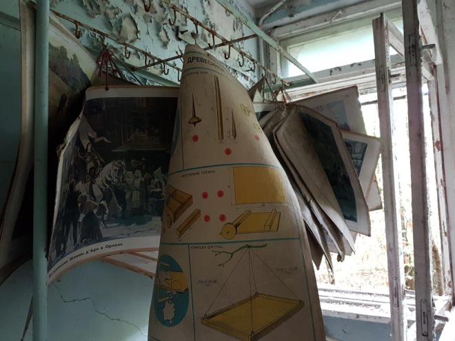 Posters with historical photos hanging side by side the woodwork instructions. Pripyat, Chernobyl, Ukraine
